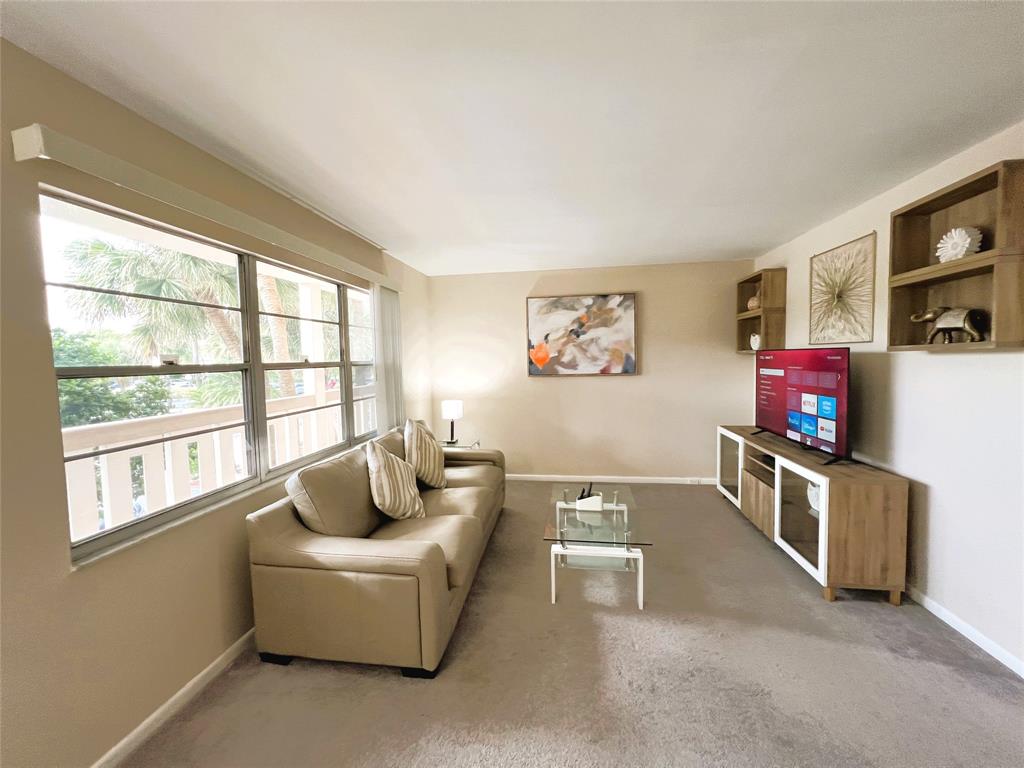 1902 Bermuda Circle, Unit H2 Coconut Creek, FL 33066 - Photo 15 of 32 a living room with furniture and a flat screen tv