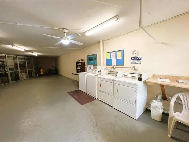 a view of a hallway with wooden floor and a bathroom