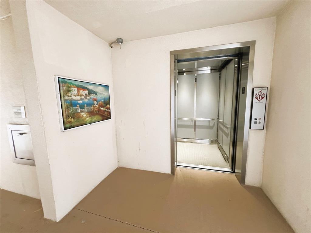 1902 Bermuda Circle, Unit H2 Coconut Creek, FL 33066 - Photo 21 of 32 a view of a hallway with wooden floor and a bathroom