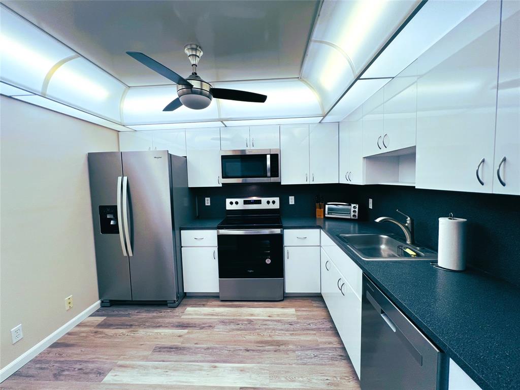 1902 Bermuda Circle, Unit H2 Coconut Creek, FL 33066 - Photo 4 of 32 a kitchen with stainless steel appliances granite countertop a refrigerator a sink and dishwasher