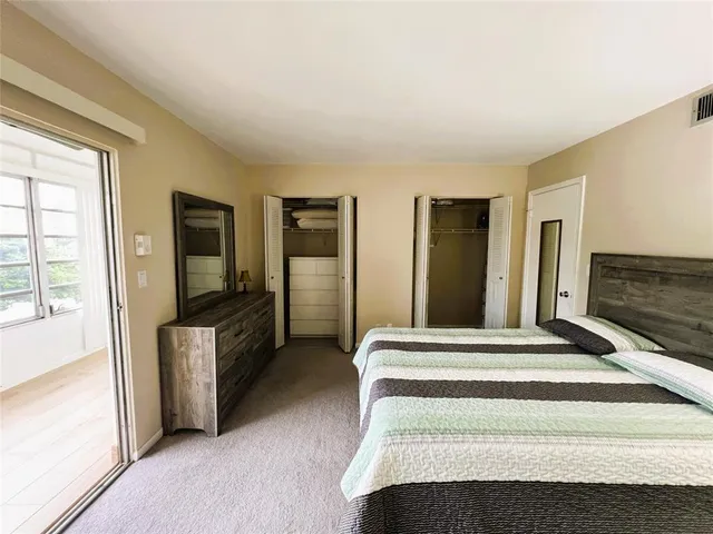 a bedroom with a bed and a view of bedroom