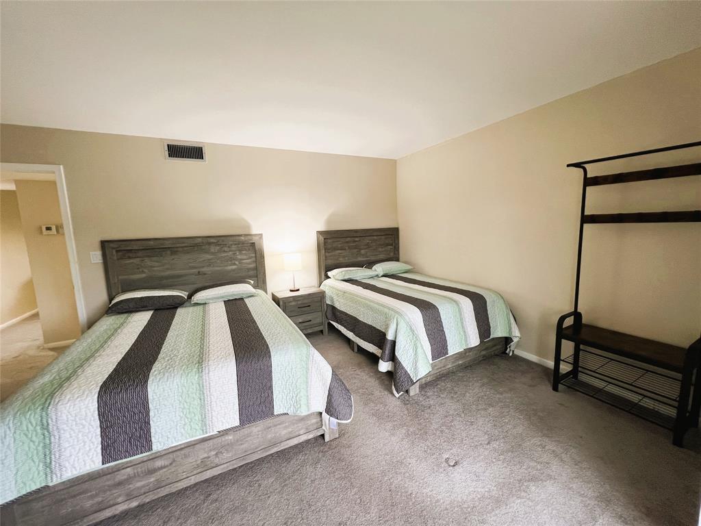 1902 Bermuda Circle, Unit H2 Coconut Creek, FL 33066 - Photo 7 of 32 a bedroom with a bed and a dresser