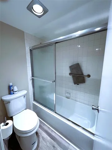 a view of a hallway to closet and wooden floor