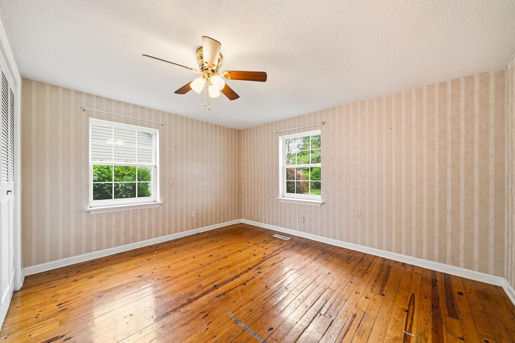 483 Allgood Road Flintstone, GA 30725 - Photo 11 of 34 a view of an empty room with wooden floor and a window
