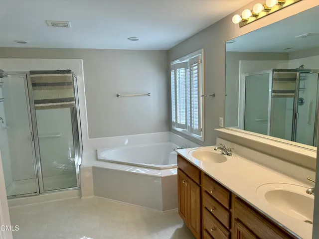 a bathroom with a tub sink and mirror