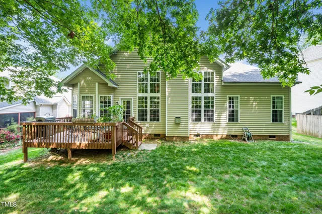 a view of backyard with a garden and deck