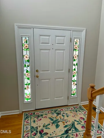 a view of an entryway with wooden floor