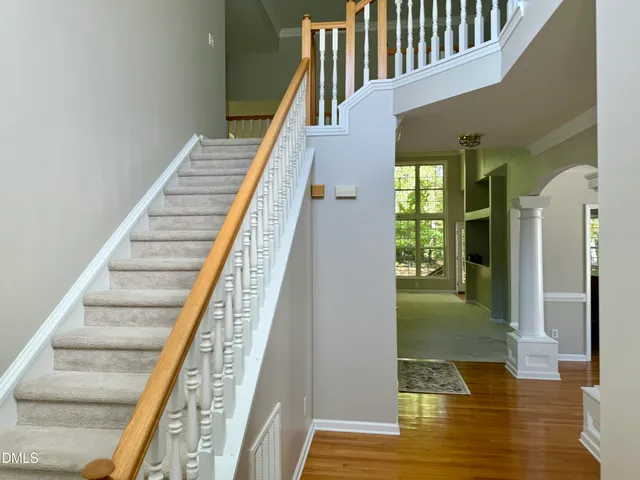 a view of entryway and hall with wooden floor