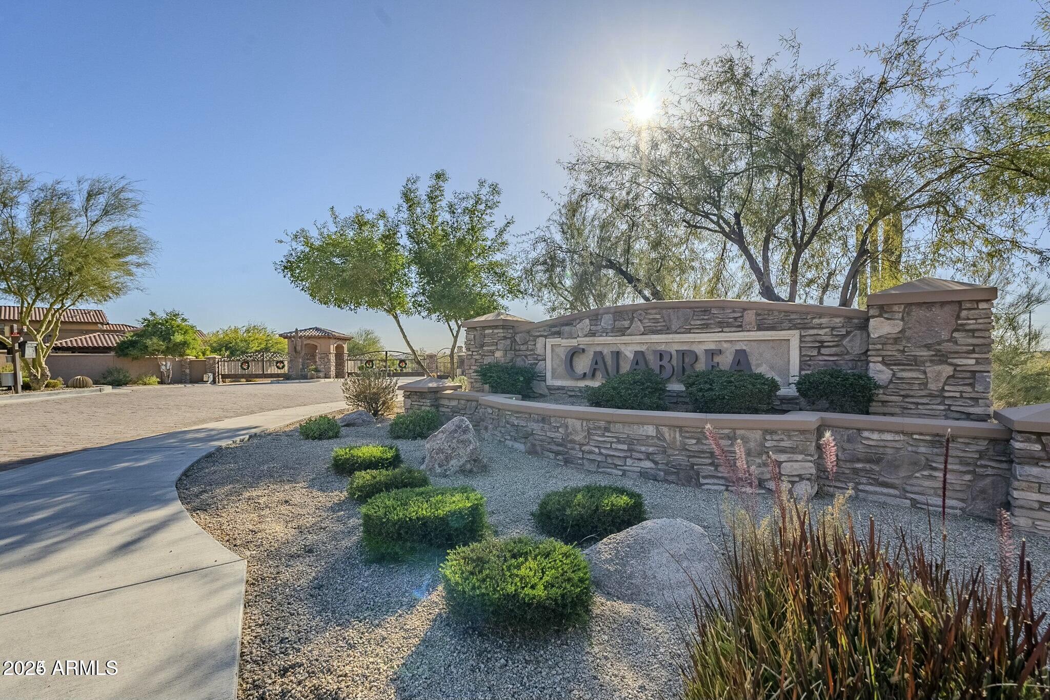 16722 South 32nd Lane, Unit 68 Phoenix, AZ 85045 - Photo 1 of 9 a view of a street with flower plants and large trees