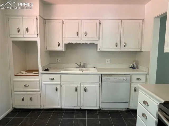 a kitchen with cabinets appliances a sink and a stove
