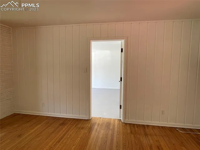 a view of an empty room with wooden floor