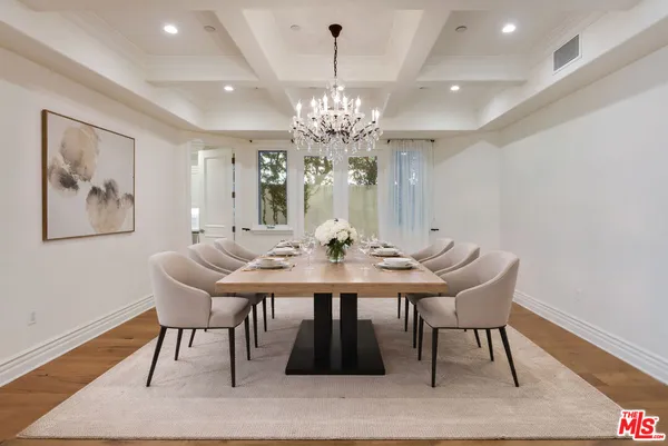 a kitchen with stainless steel appliances granite countertop a sink a stove and a wooden floors