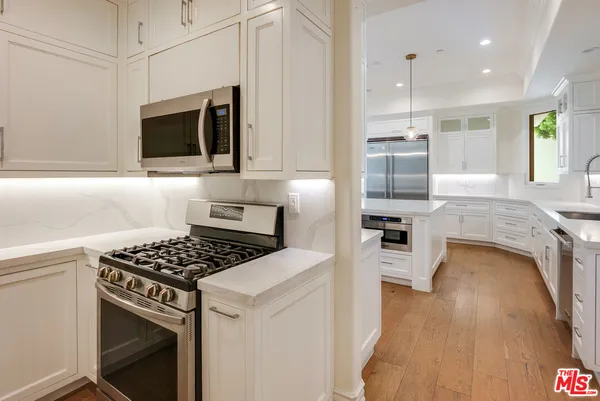 a kitchen with a stove a sink and a refrigerator