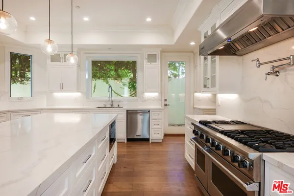 a view of a patio with table and chairs potted plants with wooden floor and fence