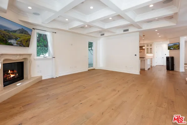 a view of staircase with lots of frames on wall and a window