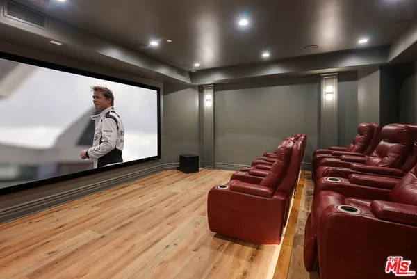 a bathroom with a toilet a sink a shower and mirror