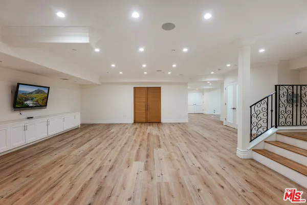 a view of an empty room with a fireplace and a window