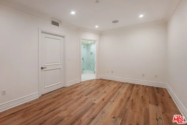 a spacious bedroom with a large bed and a fireplace