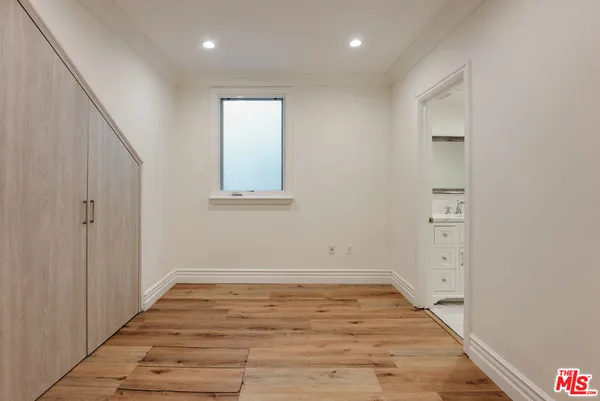 a bathroom with a granite countertop tub sink and mirror