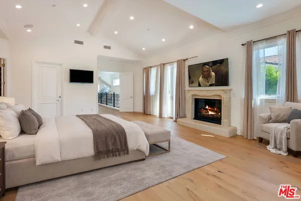 a bathroom with a granite countertop toilet sink shower and mirror