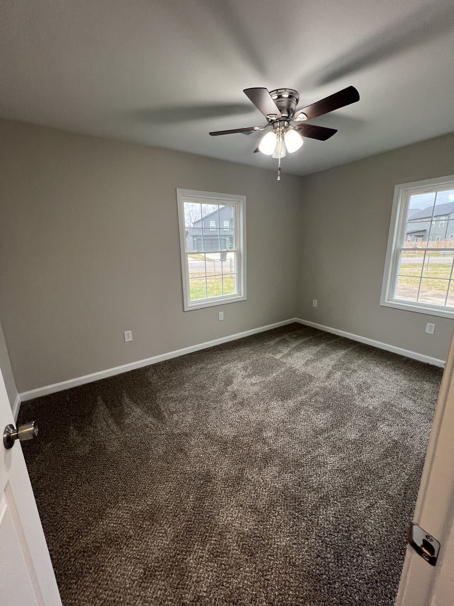 213 Notgrass Road Clarksville, TN 37042 - Photo 10 of 12 an empty room with windows and fan