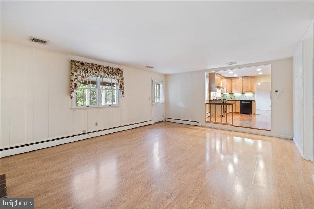 46 Hickory Lane Chalfont, PA 18914 - Photo 11 of 36 an empty room with wooden floor and windows