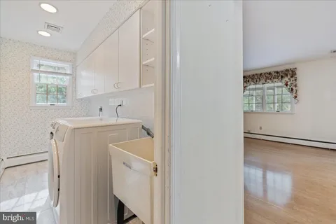 a utility room with cabinets washer and dryer