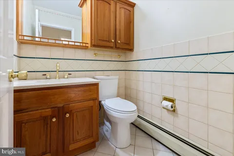 a bathroom with a sink a toilet and mirror
