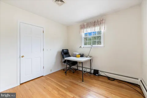 a work room with wooden floor and a window