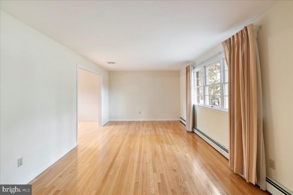 46 Hickory Lane Chalfont, PA 18914 - Photo 4 of 36 an empty room with wooden floor and windows