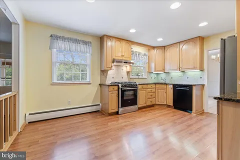 a kitchen with stainless steel appliances granite countertop a stove top oven and sink