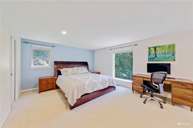 a bedroom with a bed chair and a window