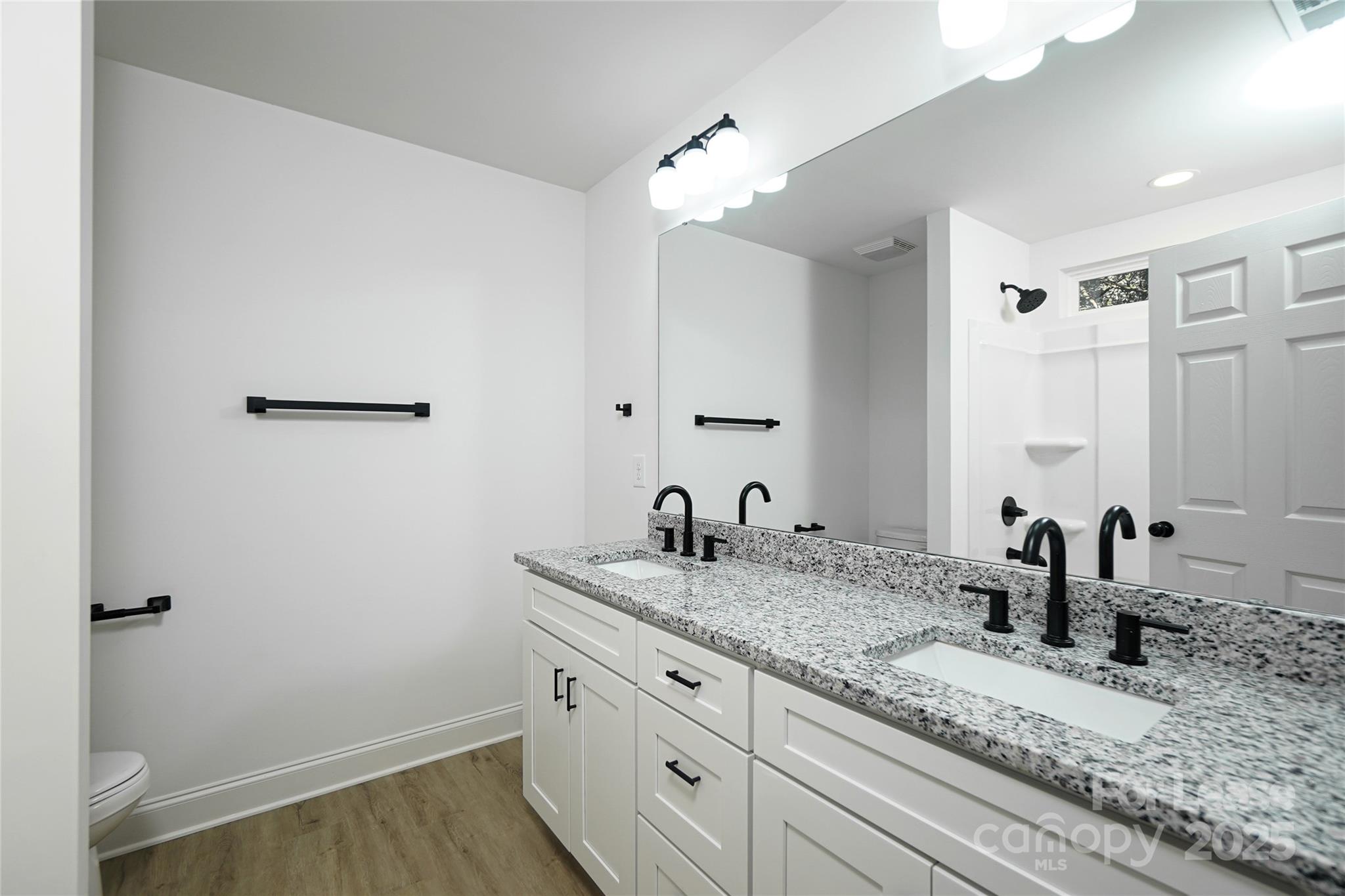 3222 Sam Wilson Road Charlotte, NC 28214 - Photo 16 of 31 a bathroom with a granite countertop sink and a mirror