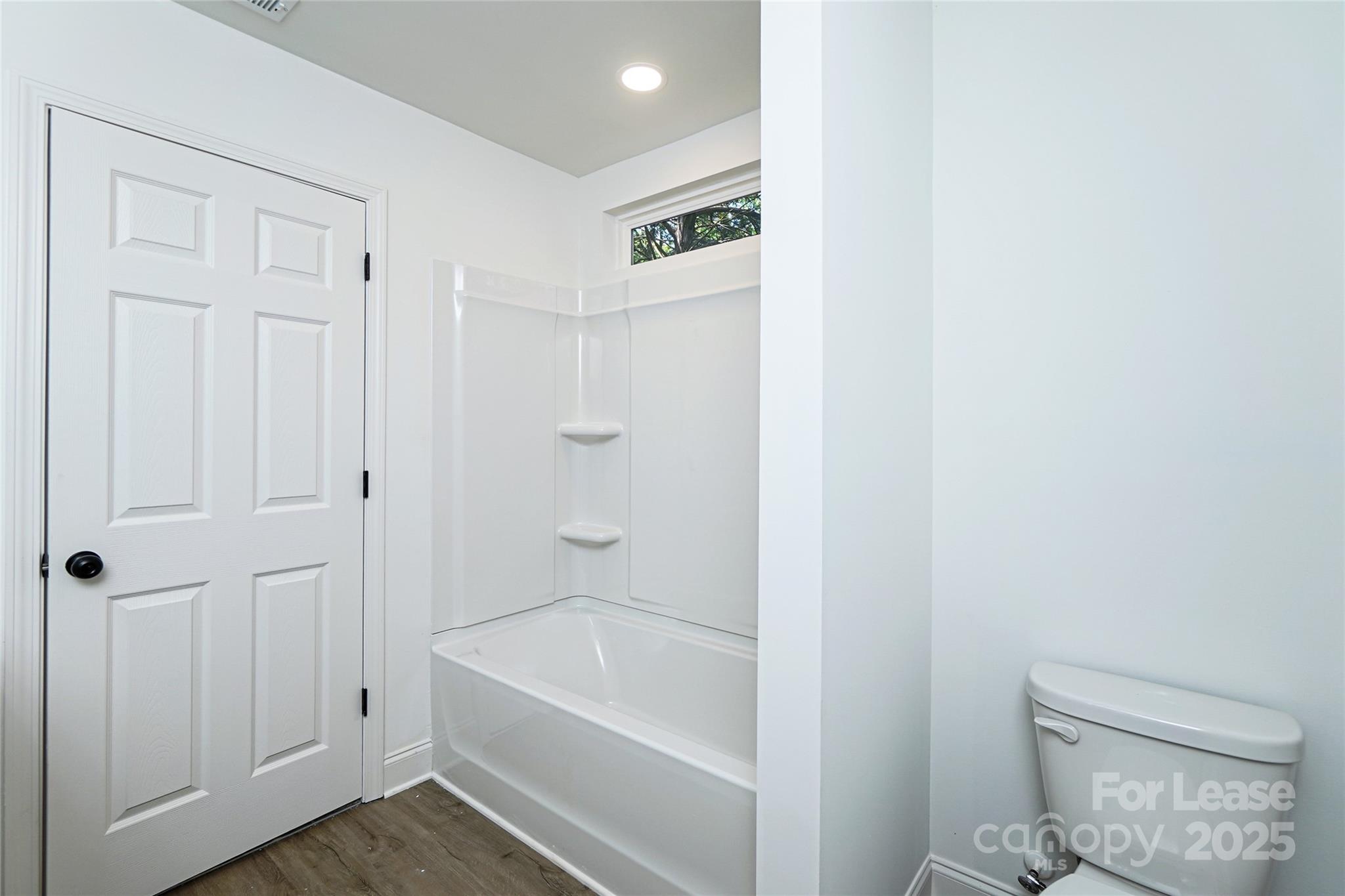 3222 Sam Wilson Road Charlotte, NC 28214 - Photo 17 of 31 a bathroom with a bathtub and a toilet