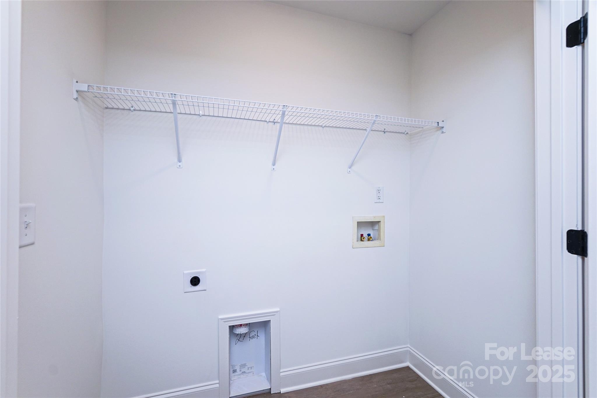 3222 Sam Wilson Road Charlotte, NC 28214 - Photo 26 of 31 a view of a room with racks on the wall