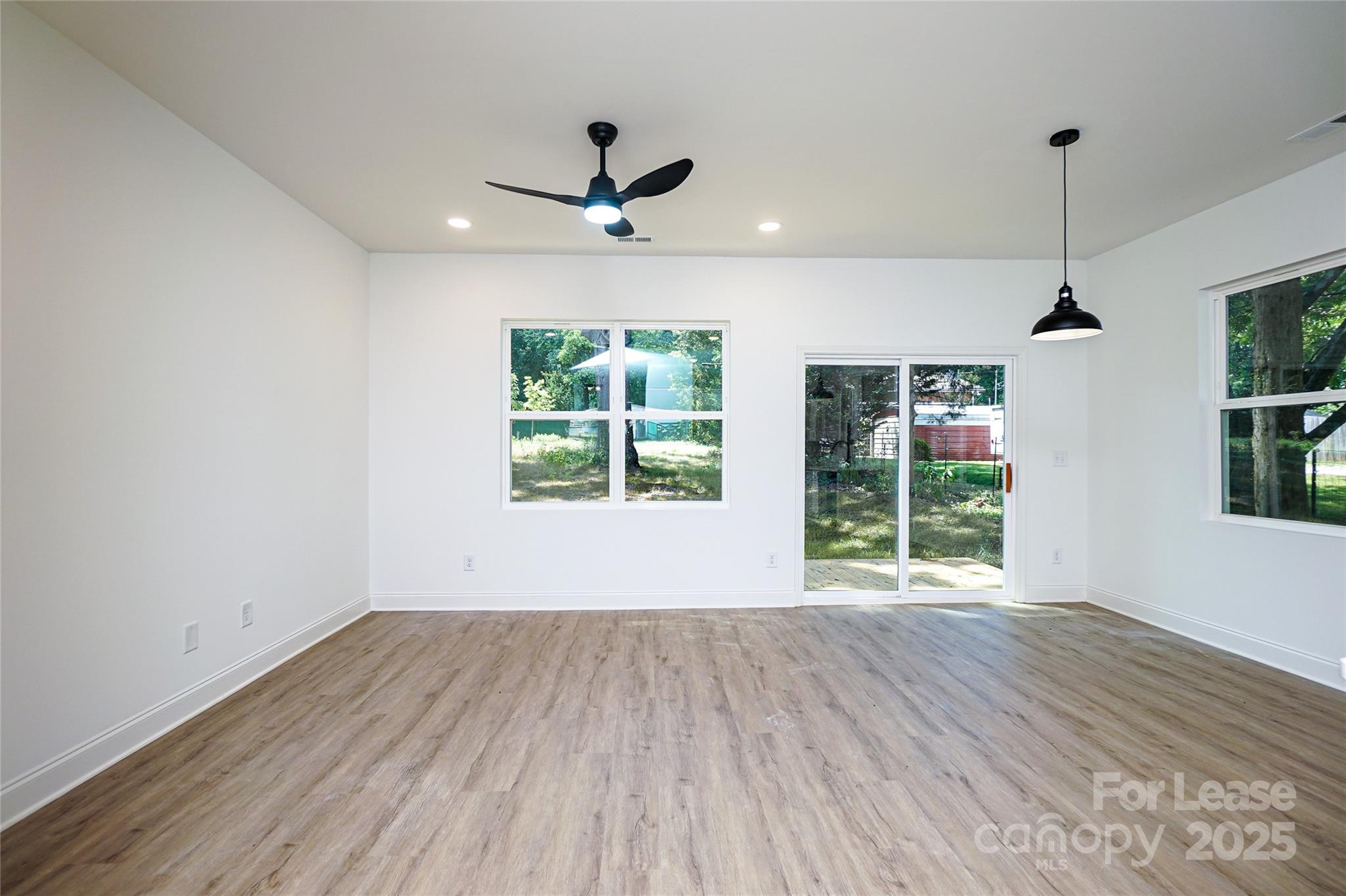 3222 Sam Wilson Road Charlotte, NC 28214 - Photo 4 of 31 a view of empty room with wooden floor and fan