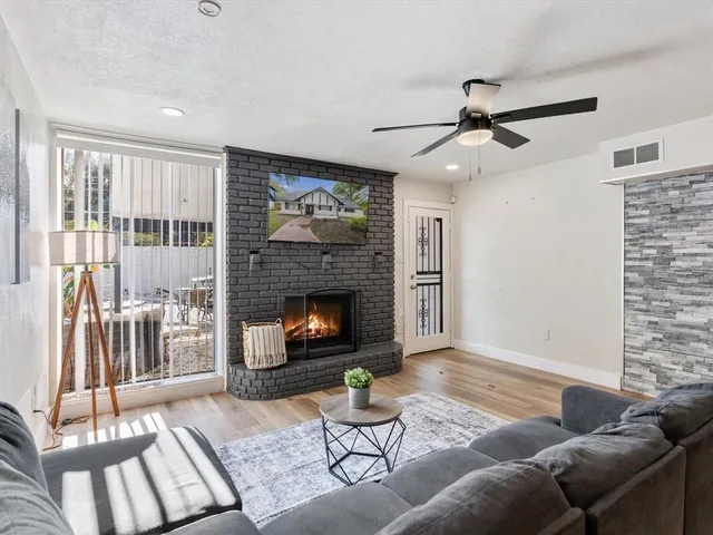 a living room with furniture and a fireplace