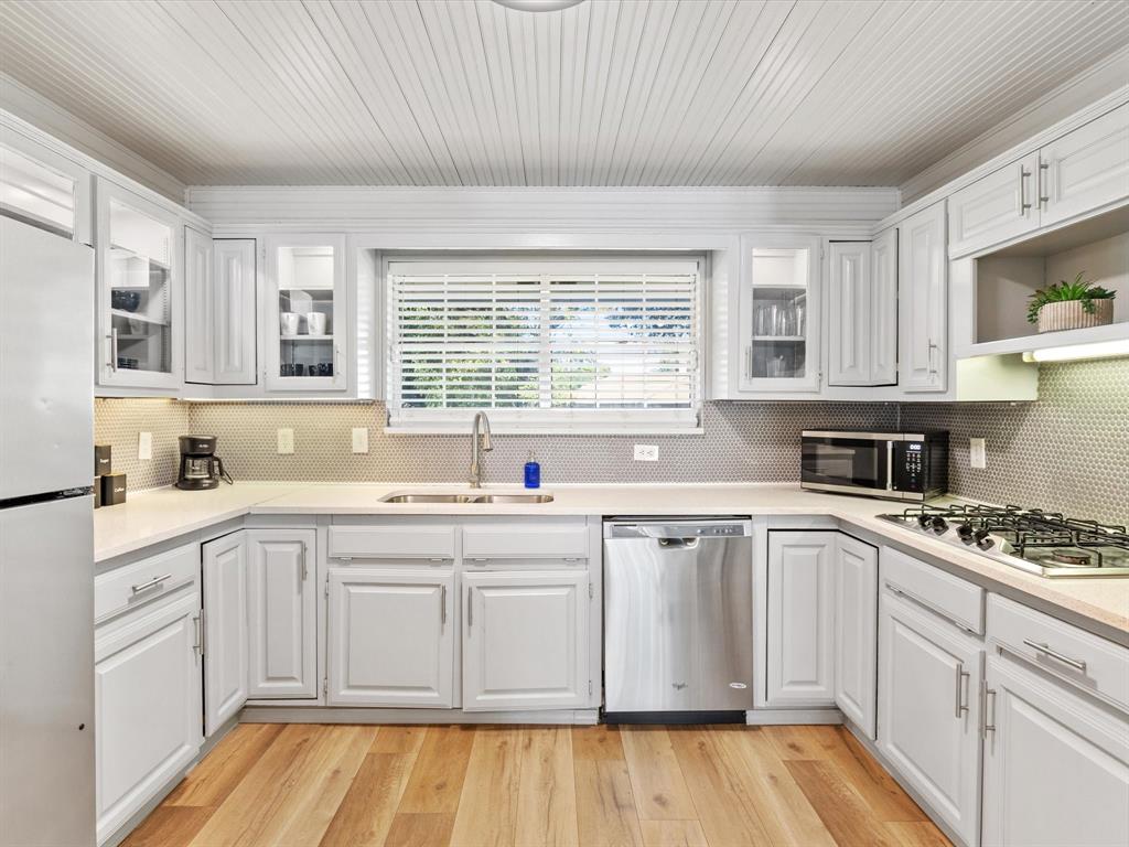 3614 Parader Court Dallas, TX 75228 - Photo 16 of 40 a white kitchen with a sink and cabinets