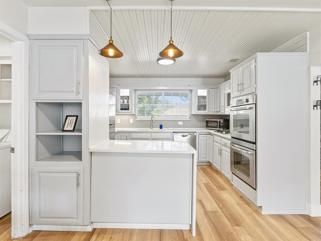 3614 Parader Court Dallas, TX 75228 - Photo 18 of 40 a kitchen with cabinets and stainless steel appliances