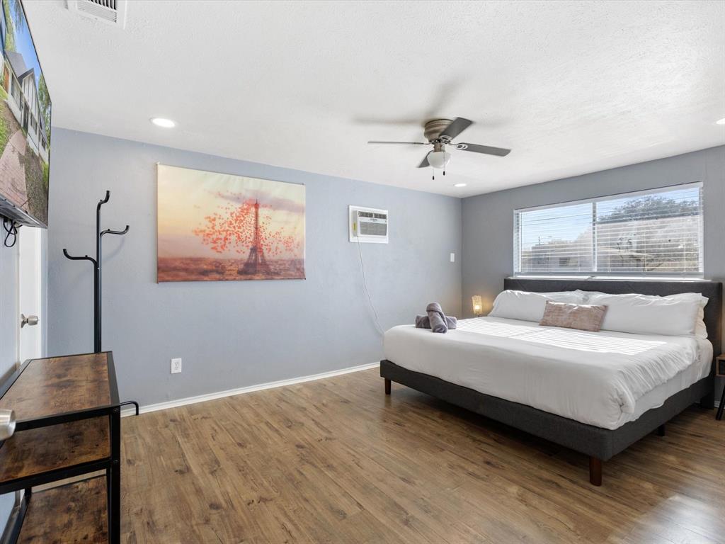 3614 Parader Court Dallas, TX 75228 - Photo 21 of 40 a bedroom with a bed and a chandelier