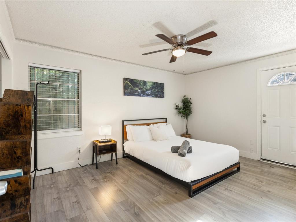 3614 Parader Court Dallas, TX 75228 - Photo 22 of 40 a living room with a bed furniture and a window