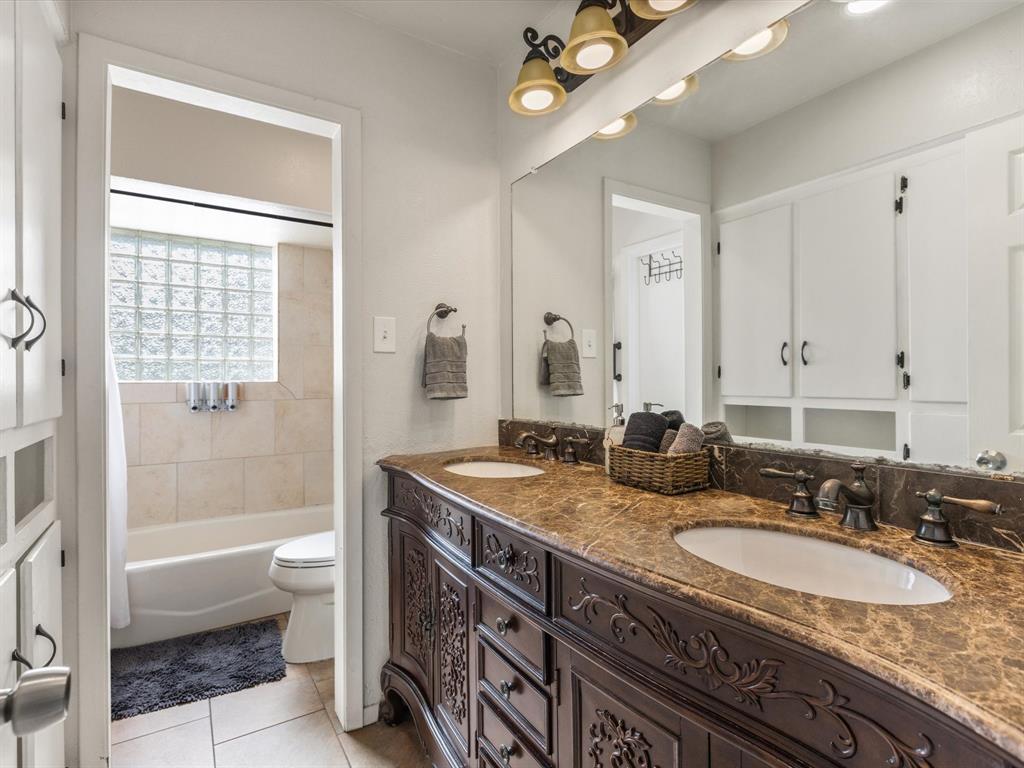 3614 Parader Court Dallas, TX 75228 - Photo 24 of 40 a bathroom with a granite countertop double vanity sink a mirror and a bathtub