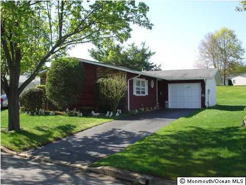 13 Markham Road Brick, NJ 08724 - Photo 1 of 3 a front view of a house with a yard and garage