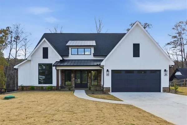 a front view of a house with yard and garage