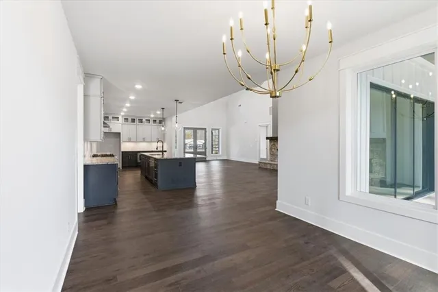 a view of a living room a kitchen and a wooden floor