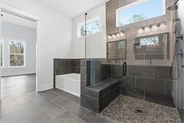 a bathroom with a bathtub and a shower