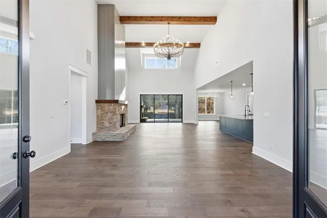 a view of an empty room with a fireplace and a window