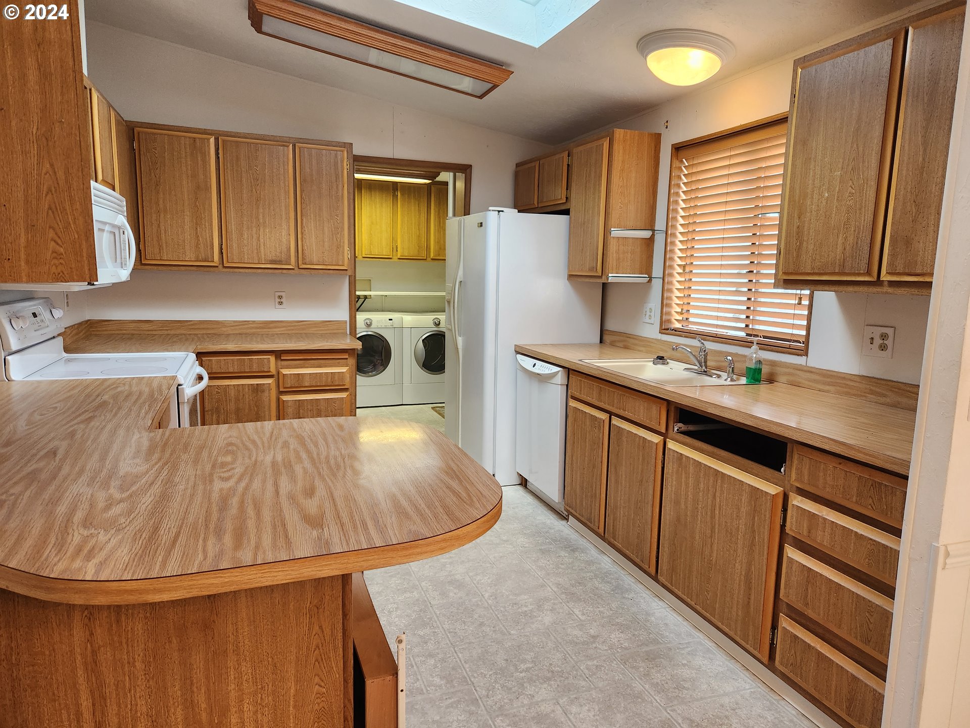 100 River Bend Road, Unit 36 Reedsport, OR 97467 - Photo 12 of 38 a kitchen with a sink appliances and cabinets