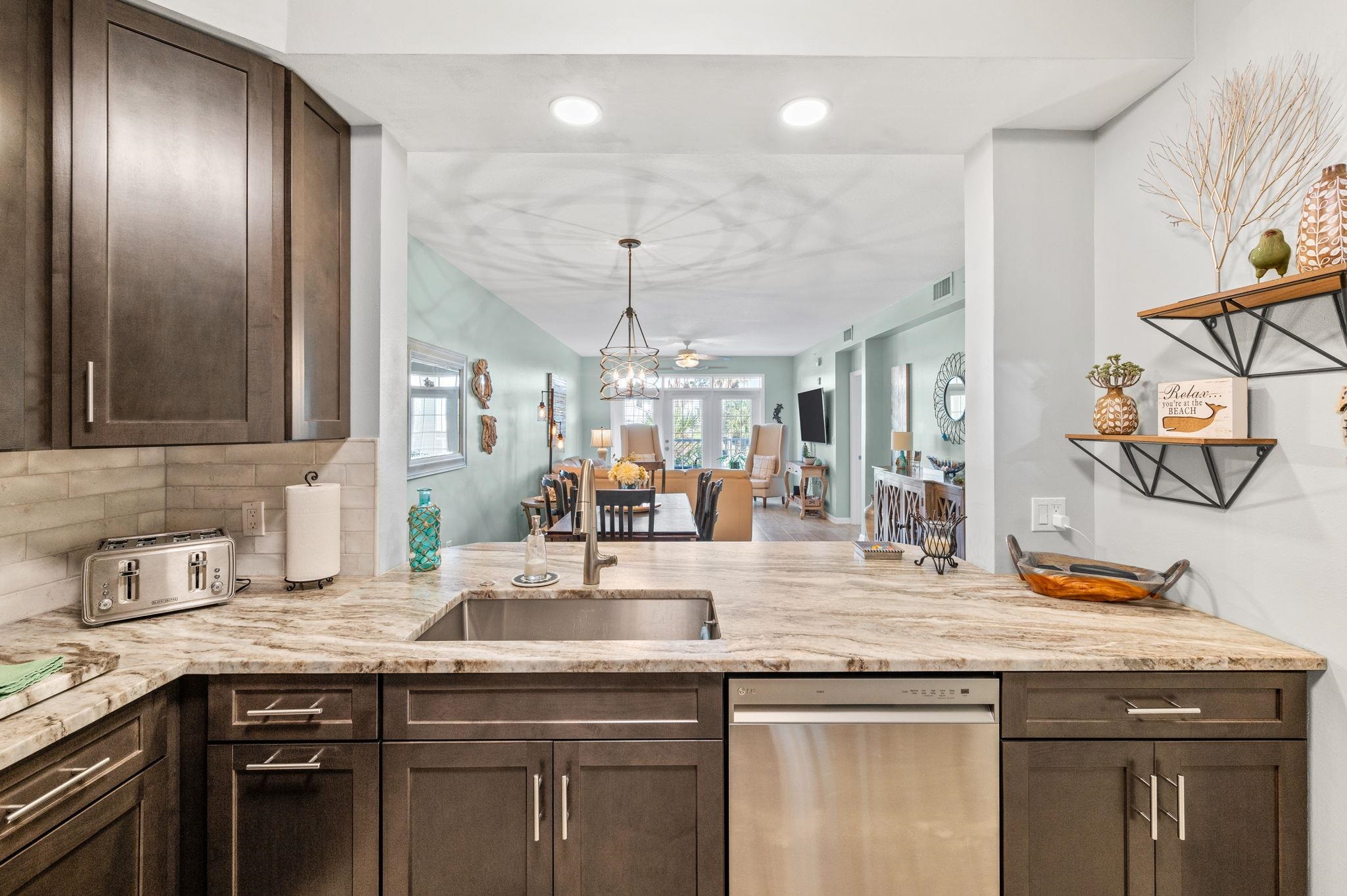 285 Atlantis Circle, Unit 203 St. Augustine, FL 32080 - Photo 17 of 71 a kitchen with a sink and a refrigerator