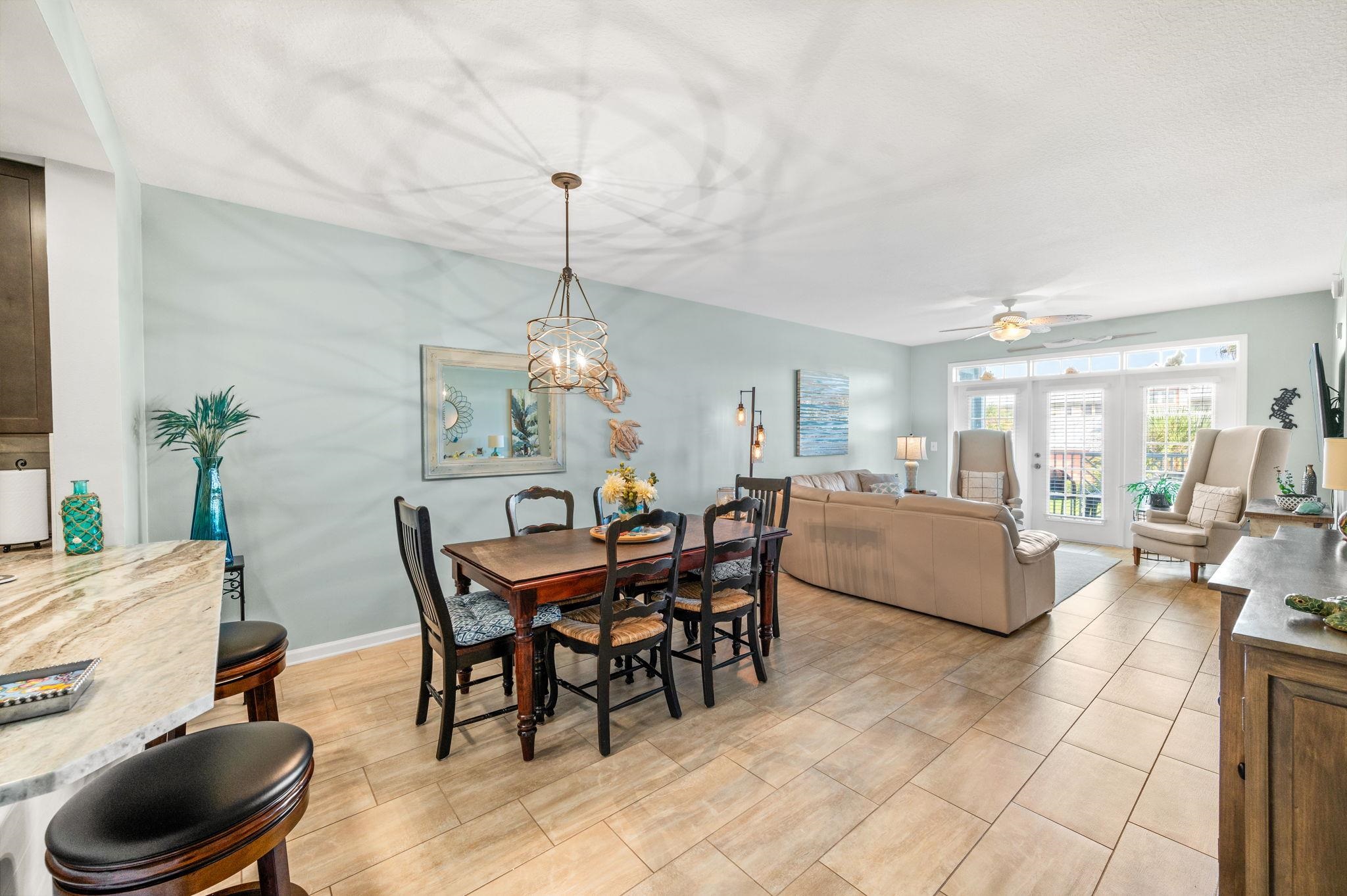 285 Atlantis Circle, Unit 203 St. Augustine, FL 32080 - Photo 19 of 71 a living room with furniture and a chandelier